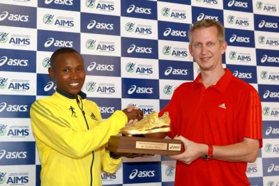 Nathan Clayton presents Geoffrey Mutai the acclaimed Golden Shoe Trophy